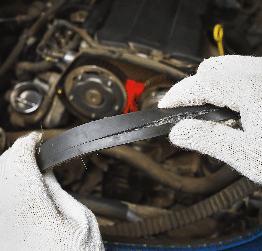 Hands inspecting damaged car engine belt.