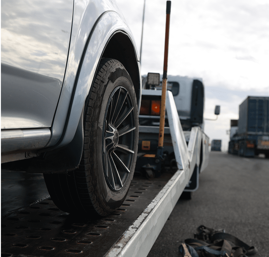 Car on tow truck, close-up view.