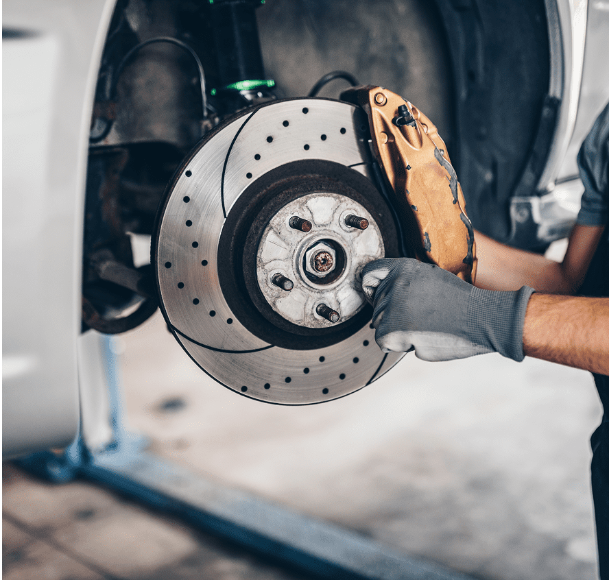 Mechanic working on car brake system.