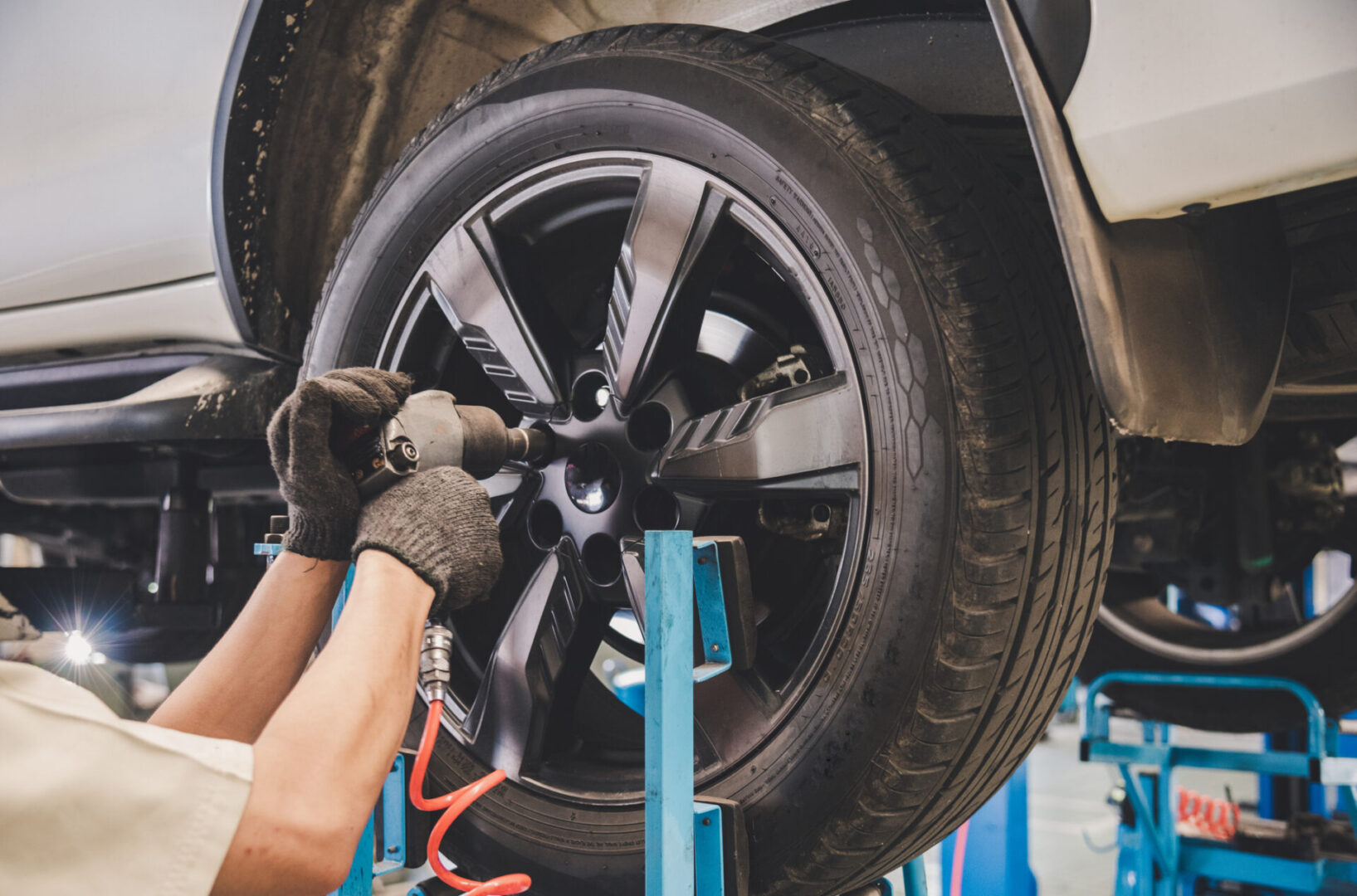 Mechanic working on car tire.