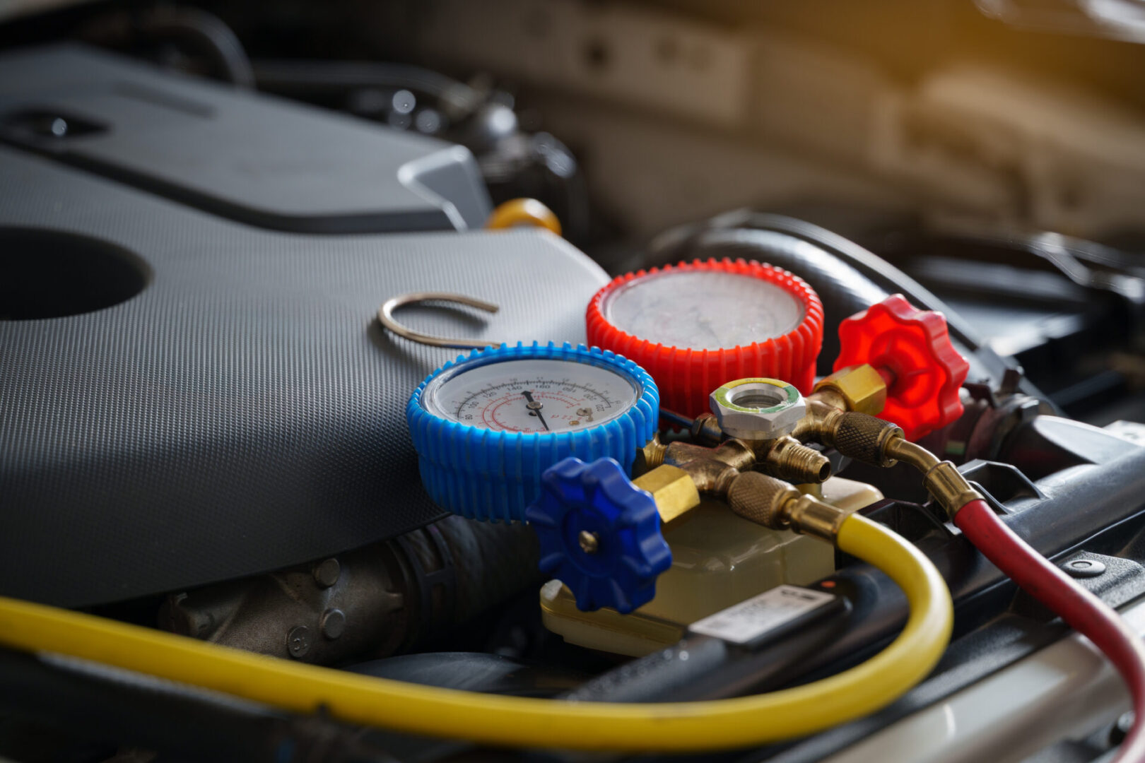 Car engine with pressure gauge connected.