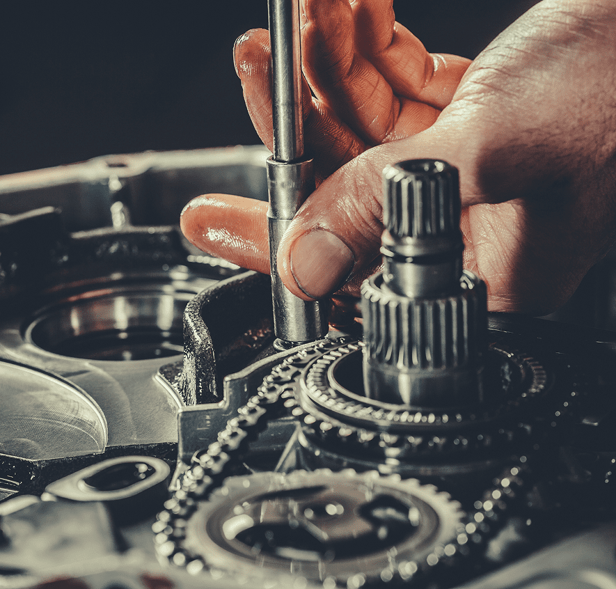 Mechanic working on car engine parts.